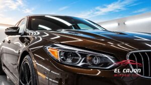 Glossy dark brown luxury sedan with reflective paint finish at El Cajon Window Tinting & Car Wraps.