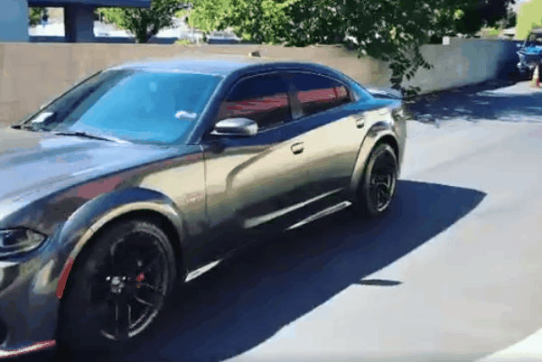 Metallic gray Dodge Charger with a glossy paint finish and tinted windows